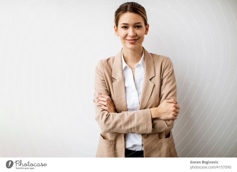 Young woman standing by the white wall in modern office adult attractive beautiful business businesswomen electronic female happy indoors looking manager one