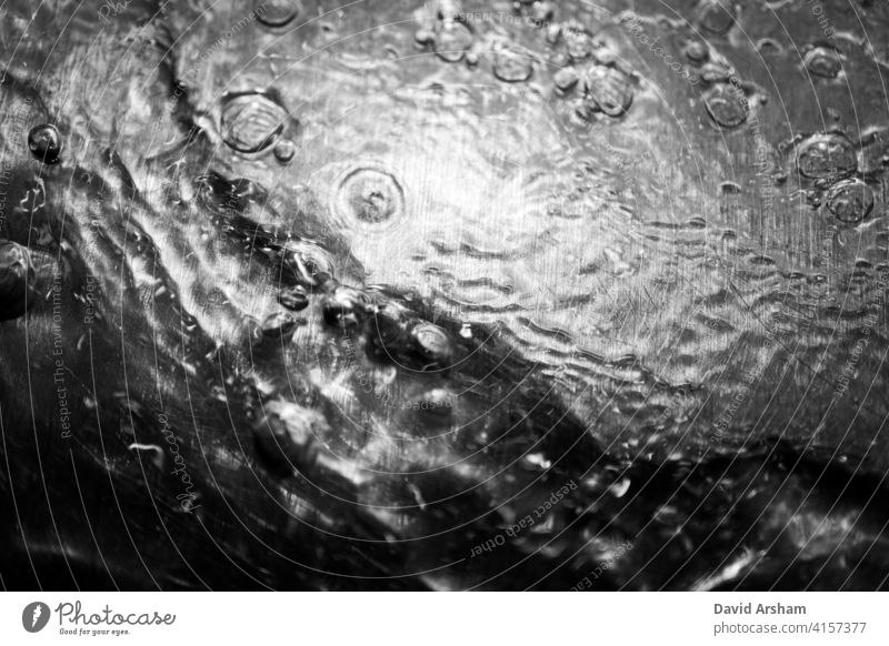High Contrast Water Ripple with Bubbles on Metal flow surface thirst disperse graphic ripple abstract moody background refreshing pure contrast macro backdrop