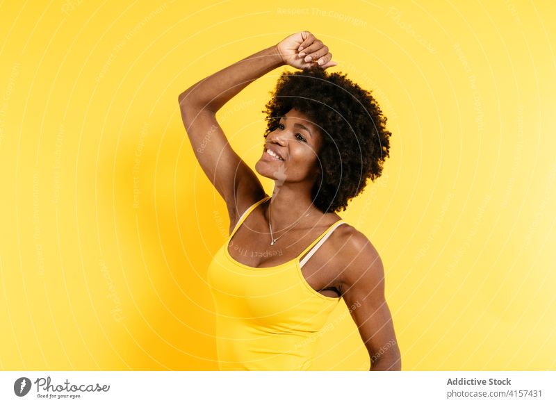 Happy black woman with curly hair smile style happy arm raised positive modern color bright female afro african american ethnic joy glad casual trendy young