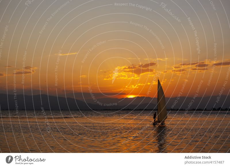 Sailing boat in the sea at sunset sailing clouds colours sunrise peace sunshine dream panoramic colourful trip wave relaxation romantic dusk silhouette freedom