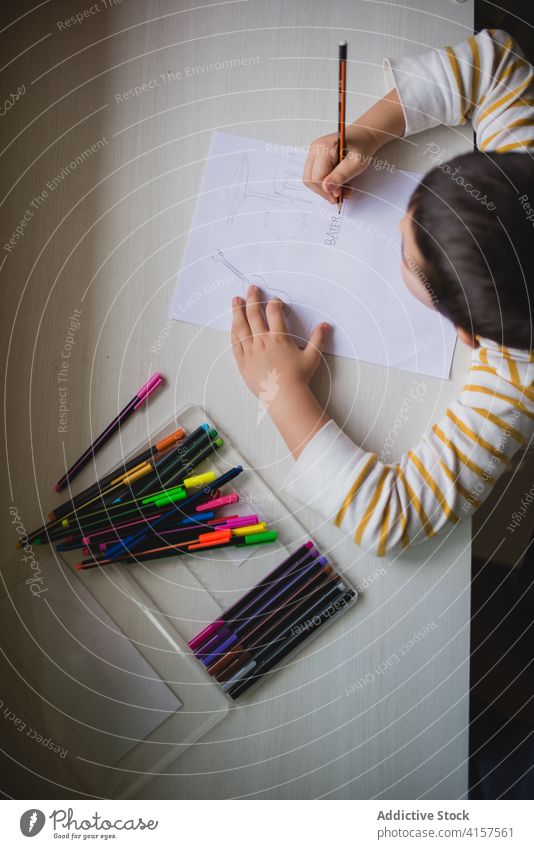 Adorable child drawing on paper picture pencil cute playful creative kid weekend home having fun entertain childhood adorable sweet charming innocent cheerful