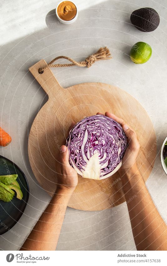 Cook putting red cabbage on cutting board cook vegetable food prepare fresh kitchen organic vegetarian purple half culinary ingredient healthy knife meal diet