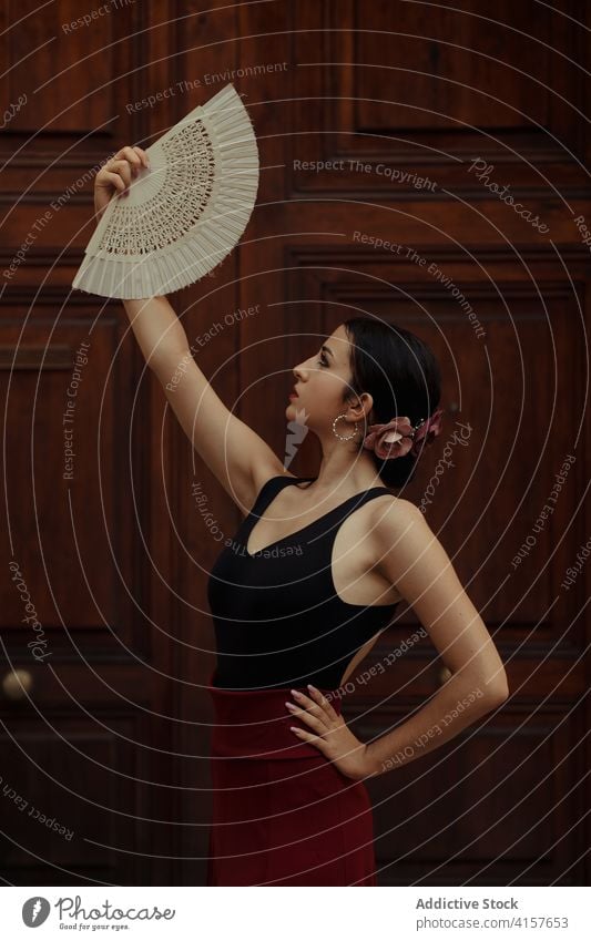 Elegant woman with fan performing Flamenco dance flamenco dancer tradition passion elegant grace hispanic female young sensual style ethnic art artist move