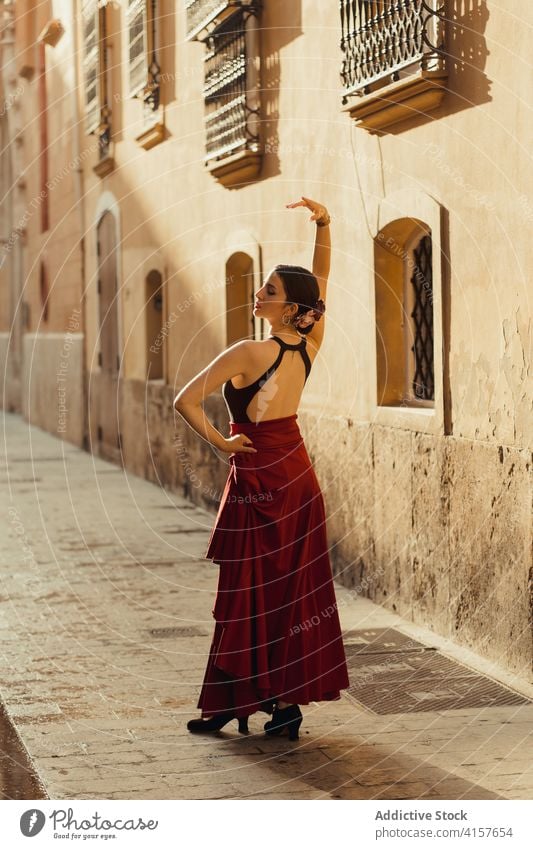 Graceful ethnic woman dancing Flamenco on old street flamenco dancer perform tradition building slim passion elegant aged historic architecture grace sensual