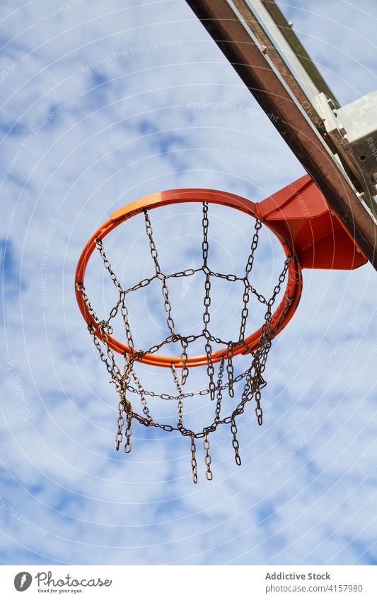 Basketball hoop with chain net basketball streetball court sports ground game activity sky cloudy playground training equipment metal workout leisure practice