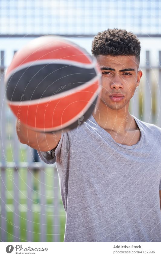 Confident black basketball player with ball confident man determine sports ground court summer sportsman male ethnic african american serious athlete sportswear