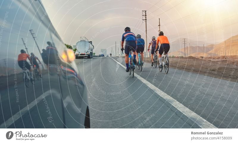 Group of professional cyclists training on highway with safety escort car, security light group cycling fitness competition sport lifestyle race biker
