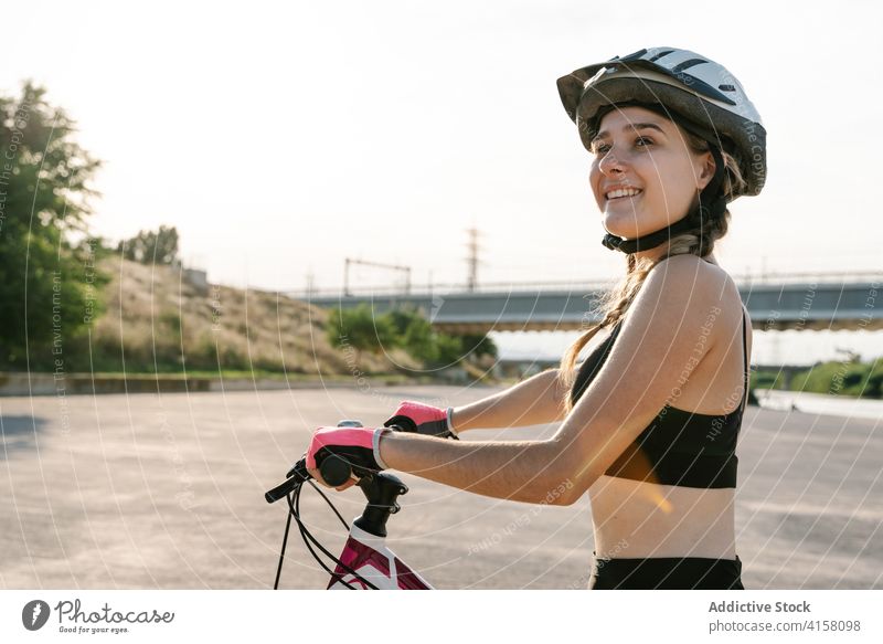 Cheerful sporty woman with bicycle cyclist happy confident ride activity bike exercise cheerful young female helmet lifestyle enjoy summer freedom adventure