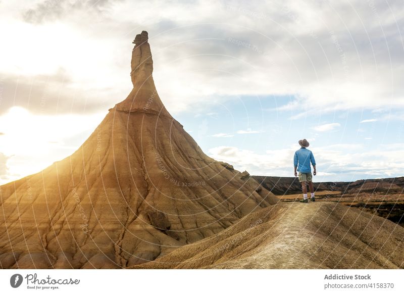 Male traveler in Bardenas Reales in summer bardenas reales man dried soil amazing scenery hill formation natural male navarra spain rocky nature landscape