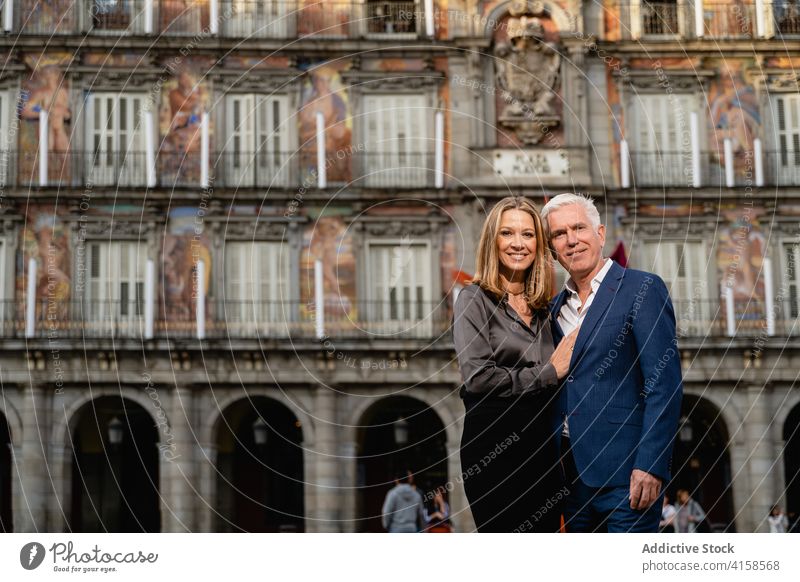 Cheerful mature couple in stylish outfits in city elegant style happy classy well dressed luxury rich cheerful embrace fashion middle age together smile