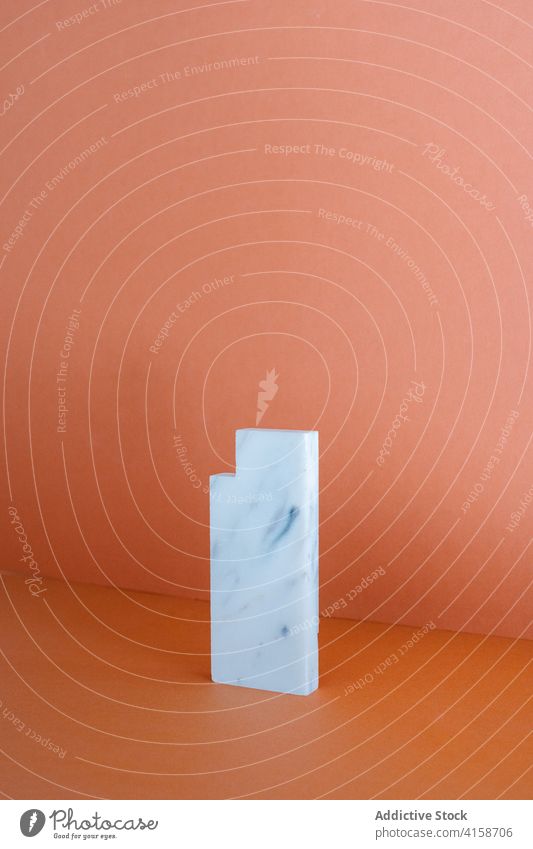 Piece of marble placed on table in studio piece art shape geometry rectangle solid material stone style design simple natural minimal creative detail surface