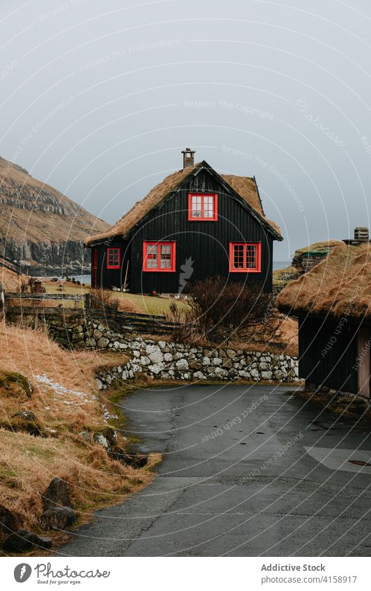 Wooden cottage on Faroe Islands on mountain village houses winter cold mountains nordic faroe islands travel coastal vacation famous place tourism