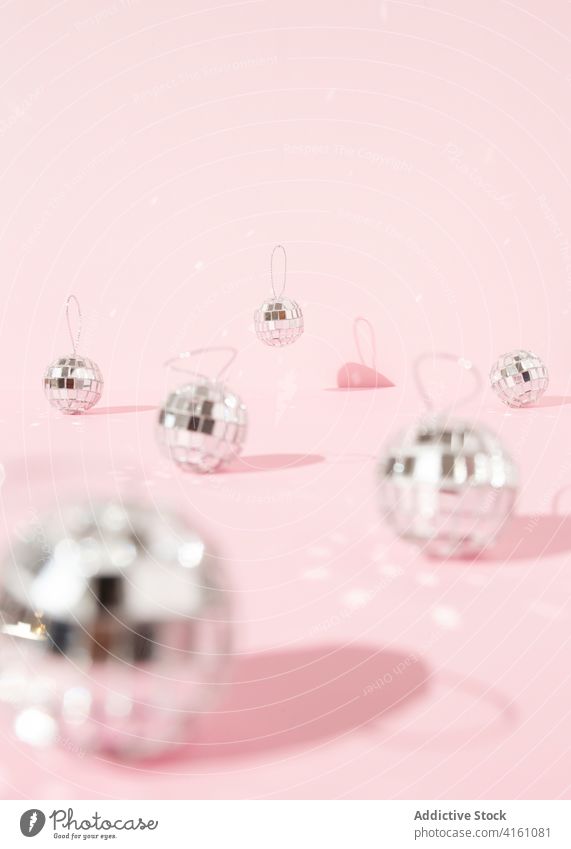 Shiny Christmas decorations on pink table christmas ball disco studio bauble shiny sparkle bright merry party new year celebrate holiday festive glow december