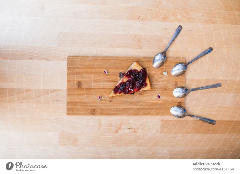 Slice of freshly baked delicious cherry pie on wooden board slice dessert yummy composition teaspoon culinary sweet pastry treat calorie homemade bakery