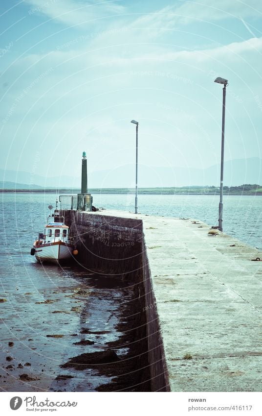 in the port Navigation Fishing boat Harbour Anchor Beautiful Small Cute Blue Calm Wanderlust Jetty Drop anchor Ireland White Lighthouse Street lighting Low tide