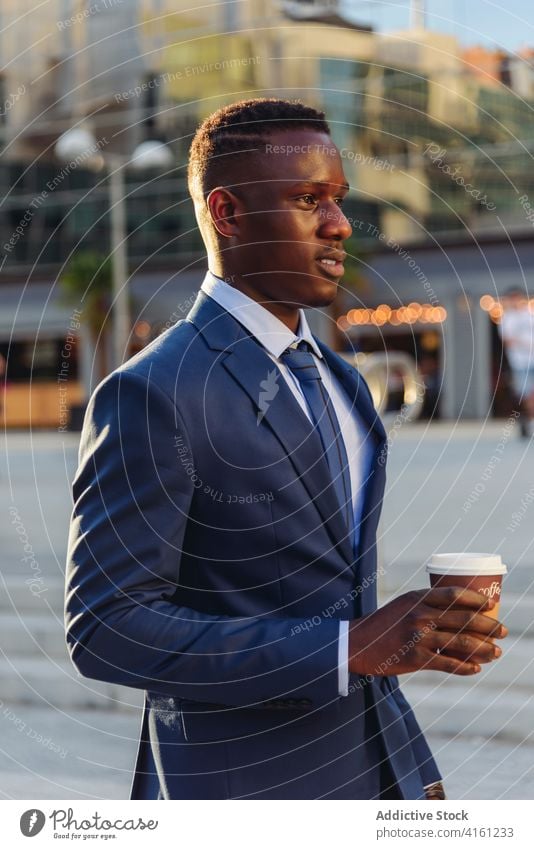 Elegant black businessman with takeaway coffee on street drink urban formal modern cup executive elegant suit manager professional adult lifestyle male