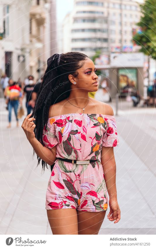 Ethnic woman in trendy wear on street pavement stylish outfit friendly black african american ornament enjoy candid portrait apparel sincere summer city afro