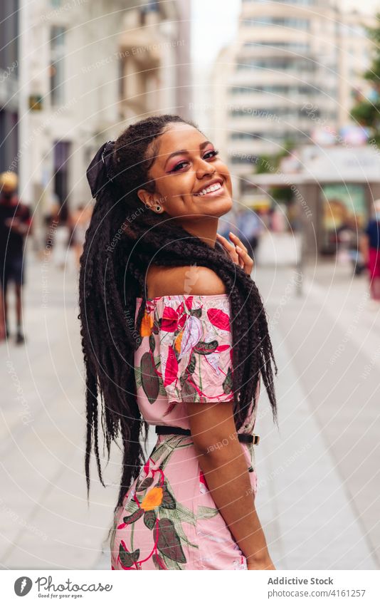 Cheerful ethnic woman in trendy wear on street pavement stylish outfit smile friendly black african american ornament enjoy candid portrait apparel cheerful