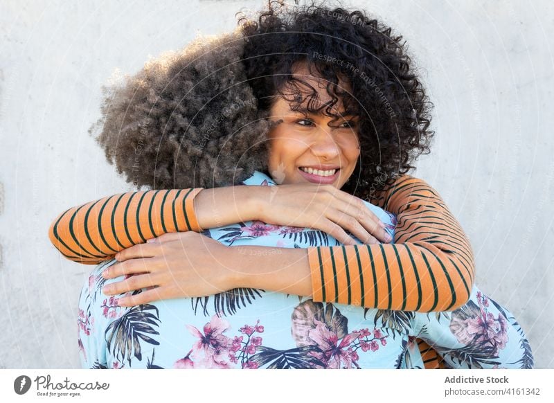 Romantic black couple embracing on street embrace romantic date love affection smile relationship hug happy relax girlfriend boyfriend young ethnic