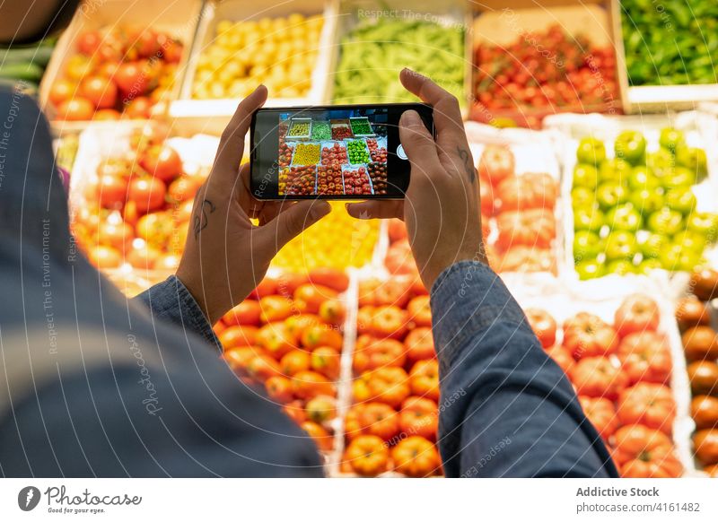 Customer taking picture of groceries on smartphone customer grocery vegetable take photo market buyer mobile food supermarket goods product fresh vegetarian