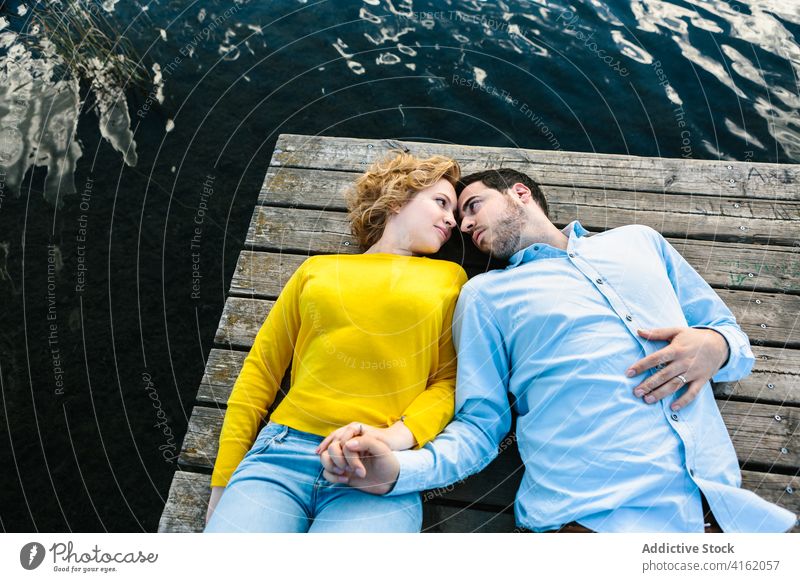 Couple in love relaxing on pier couple tender quay lake summer rest relationship gentle lying wooden romantic boyfriend water together date nature enjoy