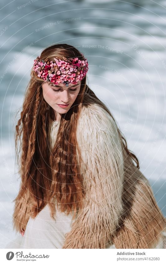 Nordic bride in fur wear standing on snowy meadow woman fashion nordic wedding style nature forest wreath season blond winter spring young female jacket floral