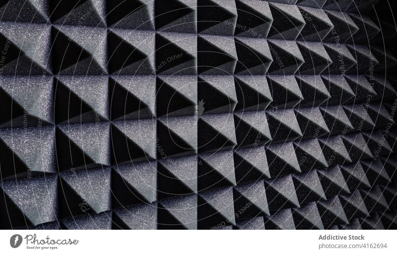 Textured background of soundproof foam pattern texture geometry three dimensional shape soft record studio wall pyramid black structure surface design material