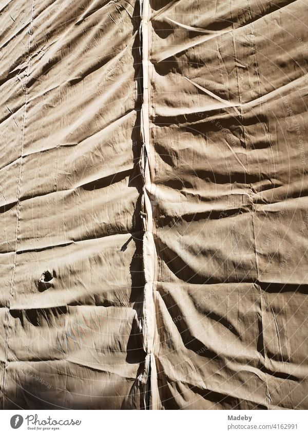 Tarpaulin in natural colours with folds on a scaffolding in the old town of Bielefeld in the Teutoburg Forest in East Westphalia-Lippe tarpaulin Fabric tarp