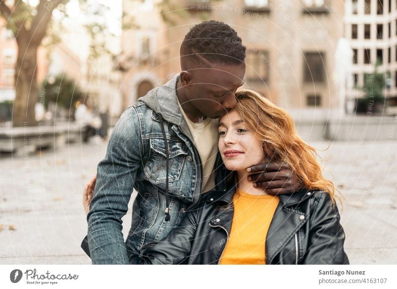 Multiethnic Young Couple kissing front view portrait relationship multi-racial black man caucasian multi-cultural multi-ethnic together boyfriend girlfriend