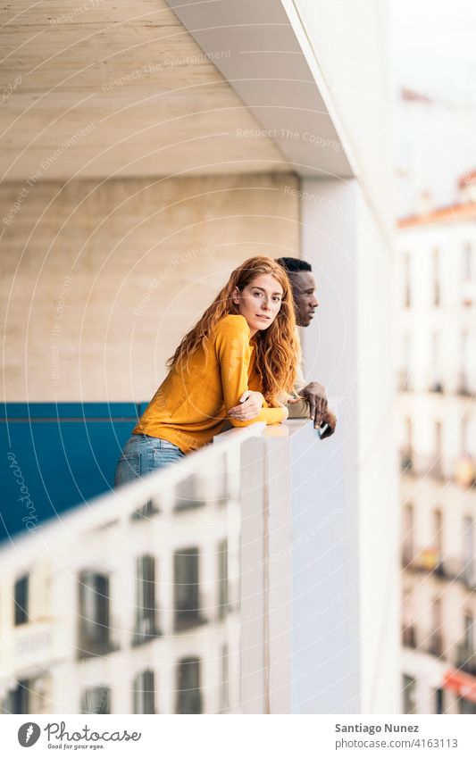 African Boy and Redhead Woman looking at camera standing front view portrait relationship multi-racial black man caucasian multi-cultural multi-ethnic together