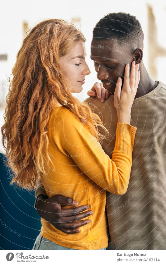Loving Multiethnic Couple Portrait looking at each other kissing portrait front view standing relationship multi-racial black man caucasian multi-cultural