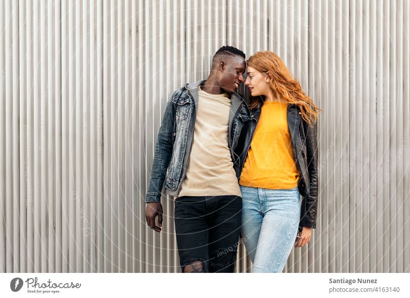 Loving Multiethnic Couple looking at each other kissing portrait front view standing relationship multi-racial black man caucasian multi-cultural multi-ethnic