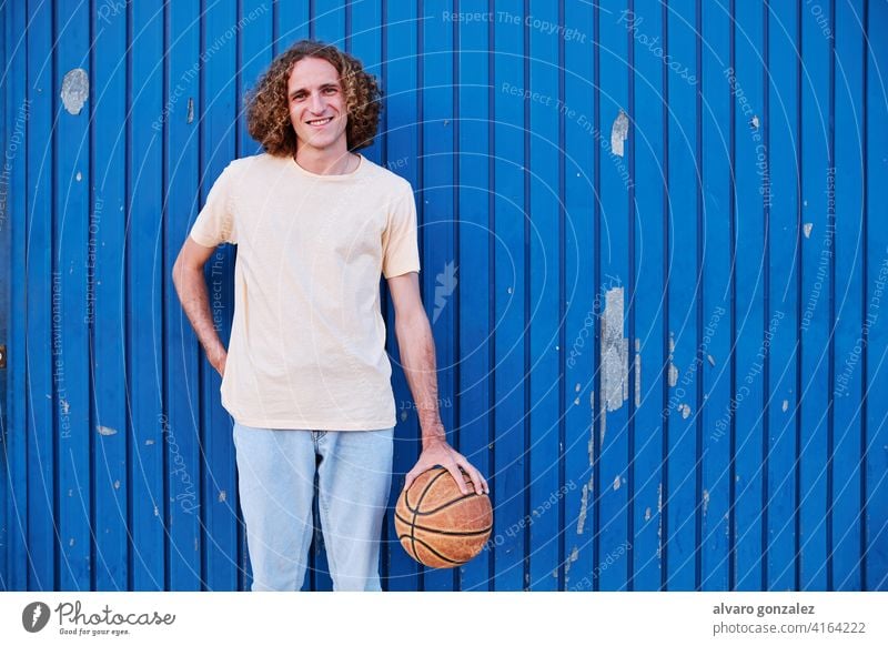 young man with curly hair with his basketball ball in his hand che person sport athletic male game player competitive background handsome isolated portrait