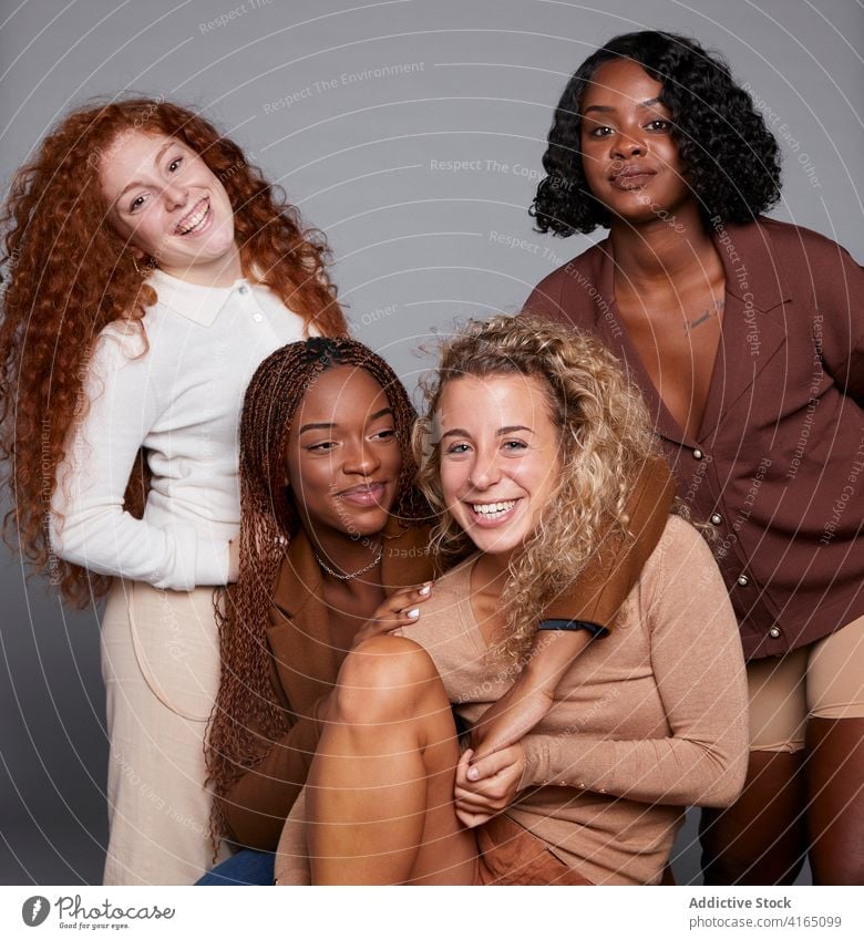Group of diverse women having fun in studio laugh friendship gather joke curly hair braid cheerful multiethnic multiracial black african american joy happy