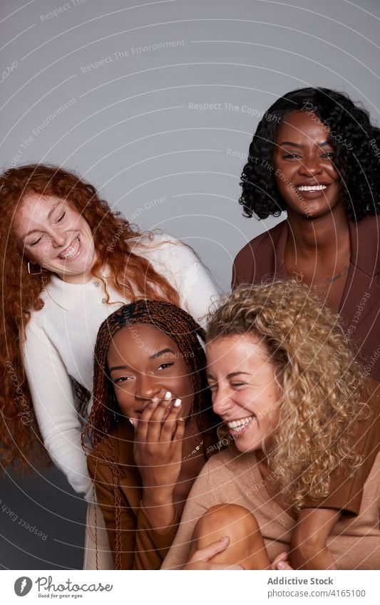Group of diverse women having fun in studio laugh friendship gather joke curly hair braid cheerful multiethnic multiracial black african american joy happy