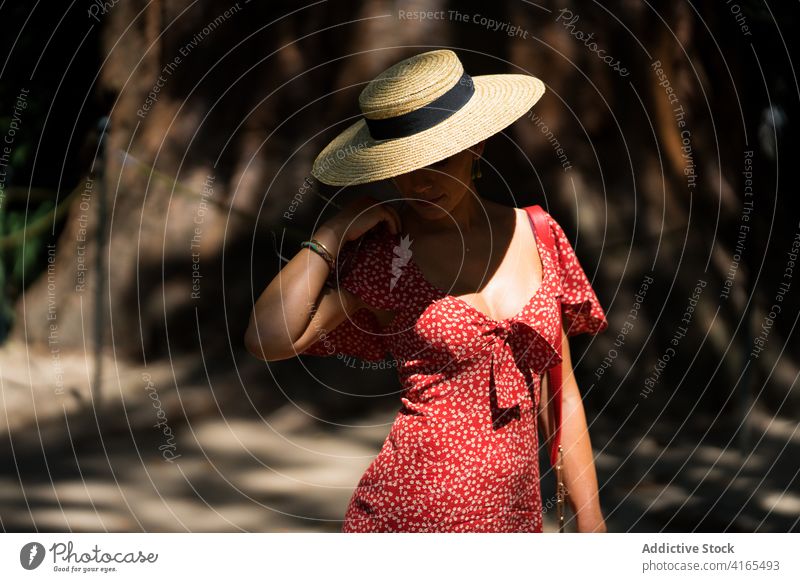 Woman in romantic outfit in city woman dress mystery elegant grace summer street style female sunlight charming straw hat sunhat sunny stroll trendy fashion
