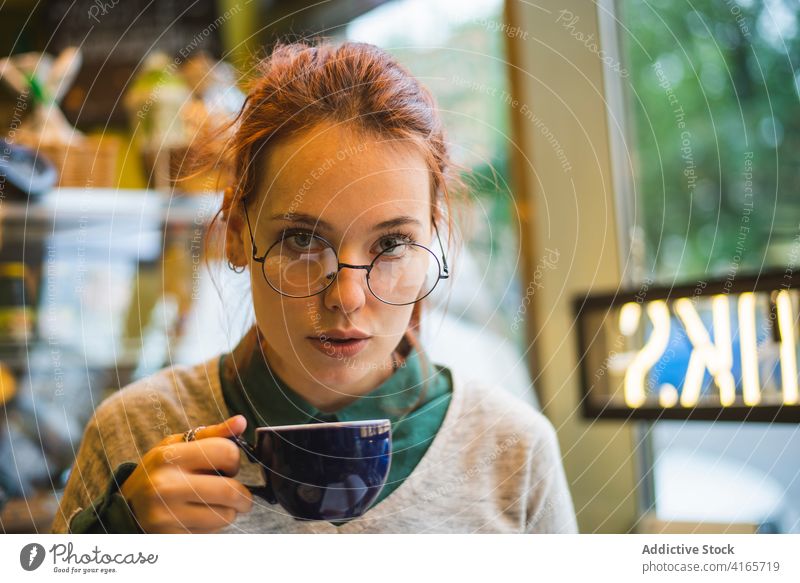 Young woman enjoying hot coffee in cafe drink style millennial hot drink aroma cozy female aromatic beverage weekend sit relax mug table cafeteria lady
