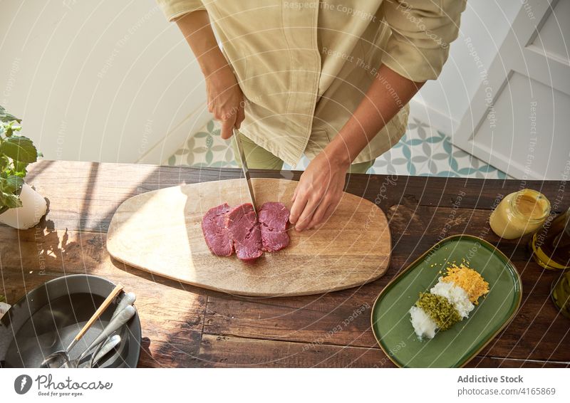 Crop woman cutting meat in kitchen beef cook steak tartare housewife prepare dinner dish female cutting board chopping board fresh wooden cuisine knife culinary