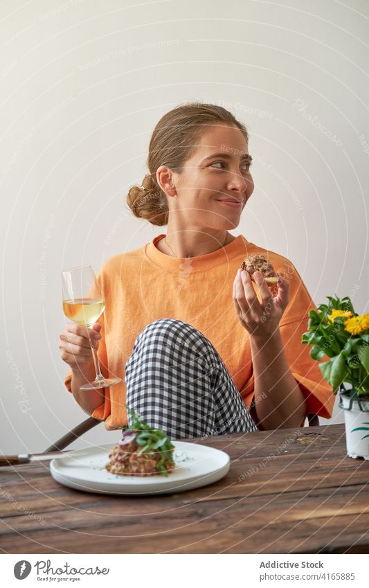 Smiling woman having tasty lunch at home steak tartare eat smiling wine drink enjoy weekend dish delight female plate table smile rest happy gourmet healthy