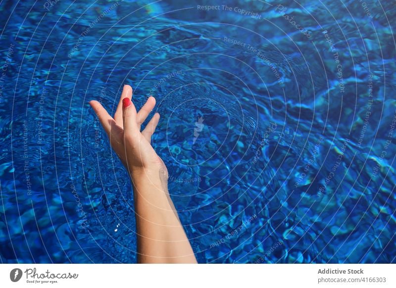 Hand of unrecognizable woman in swimming pool holiday vacation relax summer traveler hand rest recreation resort female manicure idyllic enjoy pleasure tourist