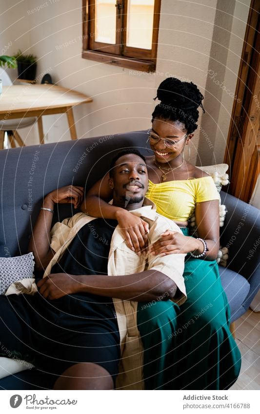 Happy black couple spending time together in cozy room love chill romantic living room weekend happy bonding lounge smile african american affection tender