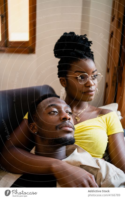 Happy black couple spending time together in cozy room love chill romantic living room weekend happy bonding lounge smile african american affection tender