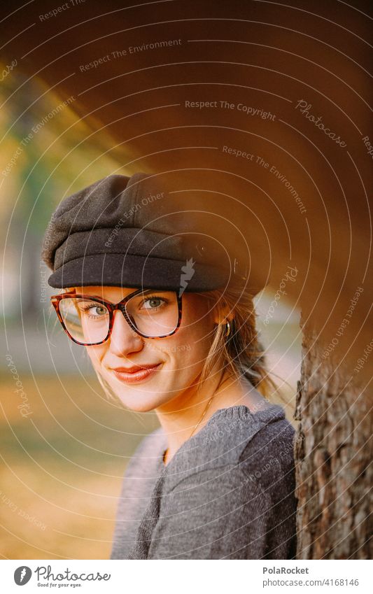 #A9# hidden look Looking covert Model Tree Ajar Nature out Forest Tree trunk Eyeglasses Face Woman Face of a woman Hat Youth (Young adults) youthful Young woman
