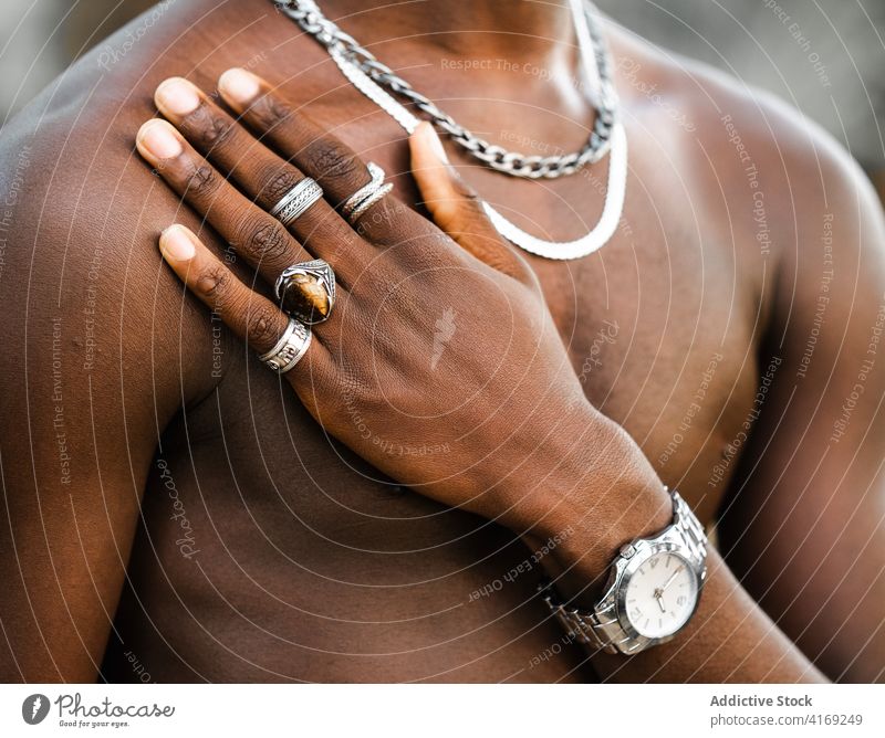 Crop black man in stylish rings hand silver accessory trendy style jewelry naked torso cool male ethnic african american shirtless fashion demonstrate