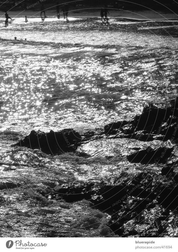 night spectacle Beach Ocean Coast Glittering Moody Waves Water Rock Stone Human being Swimming & Bathing Lamp Wind