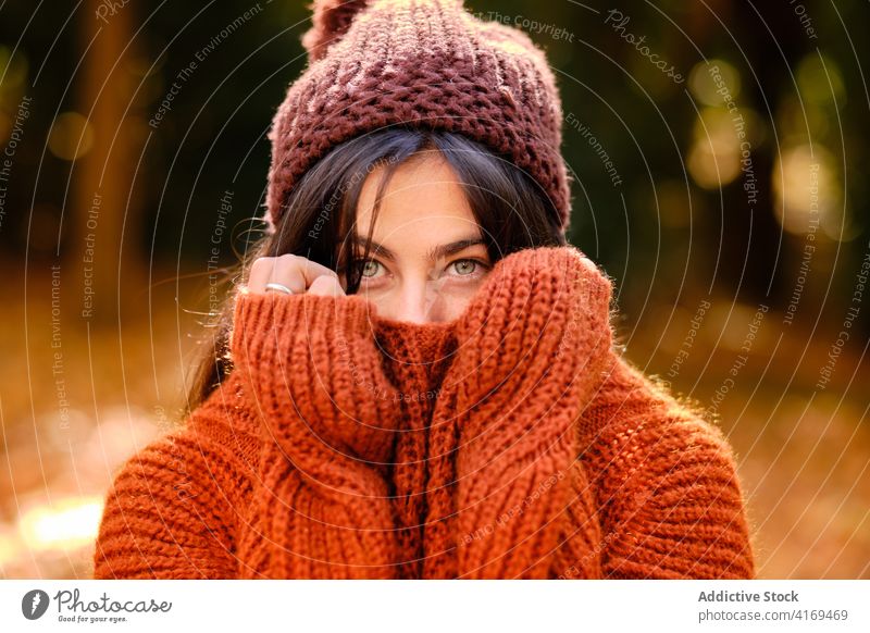 Woman in warm wear feeling cold in autumn forest woman knitted sweater hat weather warm clothes color portrait fall young female nature season park colorful