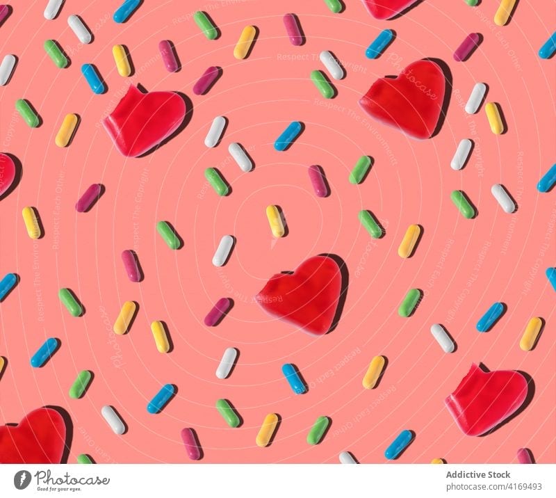 Pattern of assorted jelly candies on pink background candy pattern sweet confectionery heart shape various seamless delicious treat small colorful varicolored