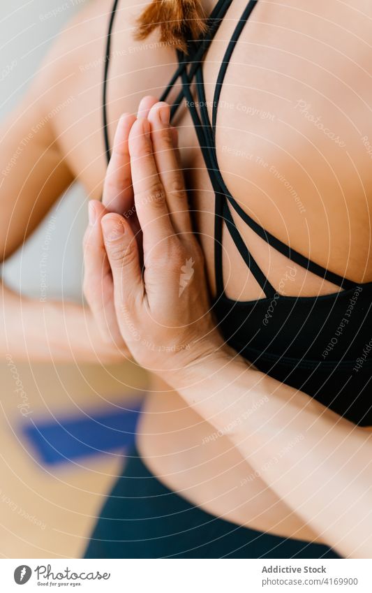 Unrecognizable woman with hands clasped behind back meditate yoga studio zen practice wellness asana lesson female slim healthy wellbeing harmony calm tranquil