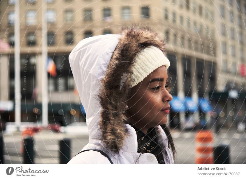 Dreamy ethnic woman in warm jacket in city stroll dreamy carefree street walk warm clothes season female black african american new york united states usa