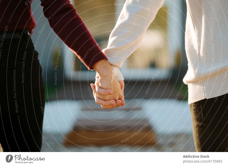 Couple in love holding hands near cottage couple touch bonding relationship together house building sunny boyfriend tender summer countryside affection romantic